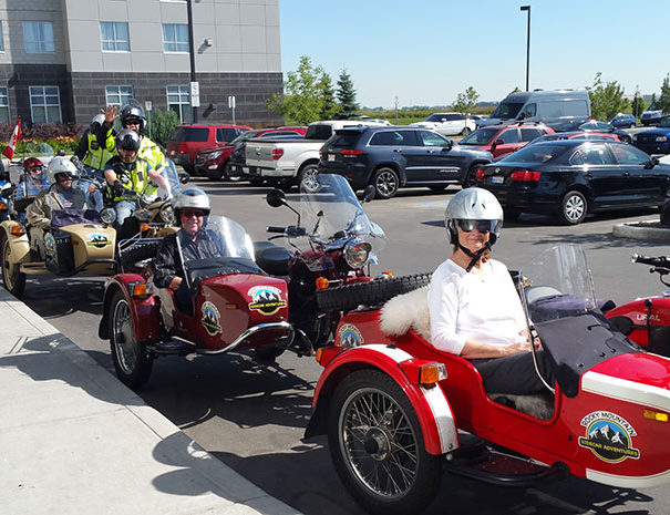 Rocky Mountain Sidecar Adventures Calgary Sightseeing Tour group parked on one of Calgary's city streets
