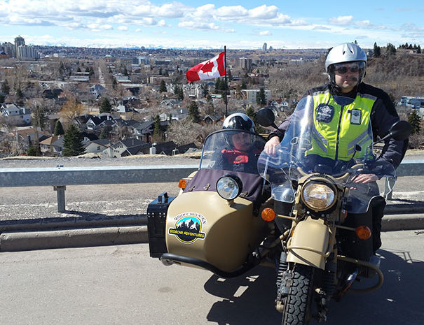 Rocky Mountain Sidecar Adventures Calgary Sightseeing Tour group with Calgary skyline in background