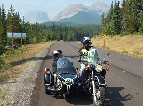 Rocky Mountain Sidecar Adventure tour group on a beautiful scenic road outside of Calgary