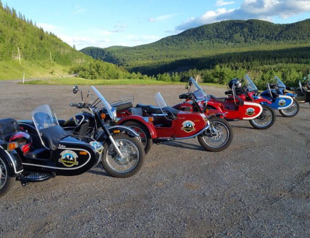 Rocky Mountain Sidecar Adventures picture of the bikes and sidecars with the rolling foothills behind them