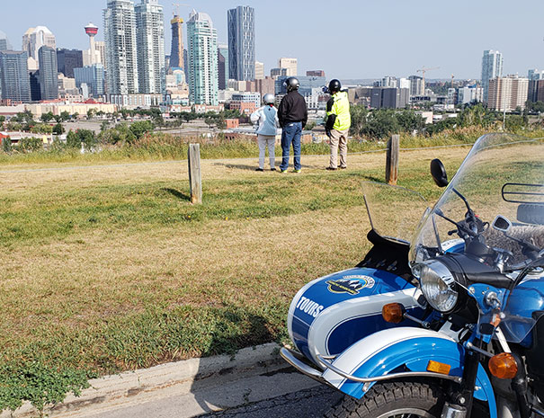 Rocky Mountain Sidecar Adventures Calgary Sightseeing Tour customers checking out the views of Calgary