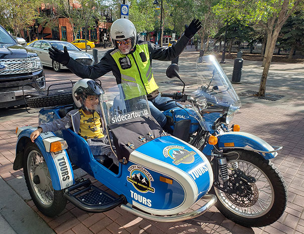 Rocky Mountain Sidecar Adventures Calgary Sightseeing Tour's younger customer checking out the cool sidecar