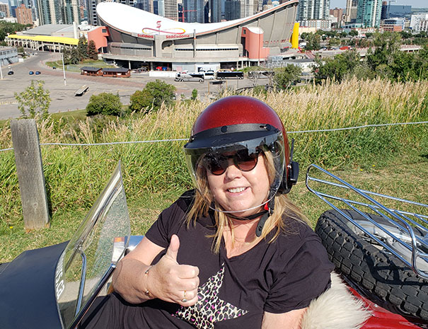 Rocky Mountain Sidecar Adventures Calgary Sightseeing Tour group with Calgary Saddledome in background