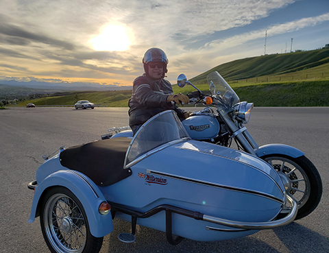 Rocky Mountain Sidecar Adventure's Owner Warren riding a bike with sidecar